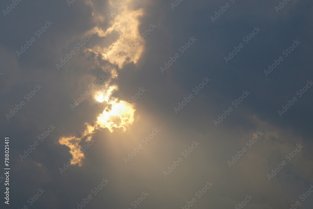 Fototapeta premium Dramatic afternoon with sunlight coming out of the clouds. Cloudy sunset. Rays of light