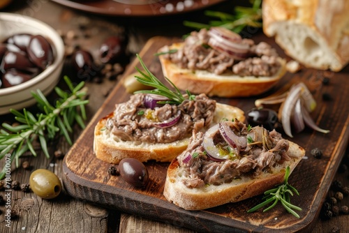 Homemade chicken liver pate on ciabatta with onions and olives on wooden table