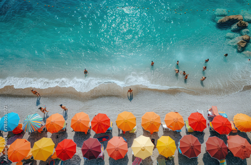 Colorful umbrellas dotting a lively summer beach