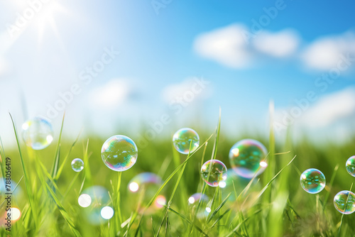 Soap bubbles in the grass, sky and sun in the background, copy space.