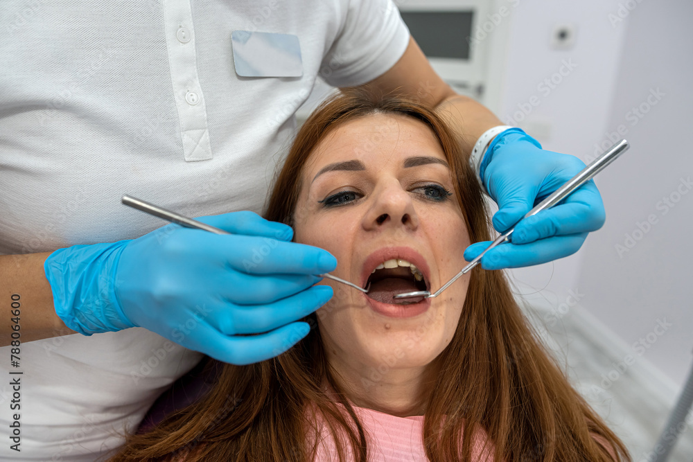 frightened girl who is afraid of visit to dentist sits in chair does not want dental procedure frightened girl who is afraid of visit to dentist sits in chair does not want dental procedure