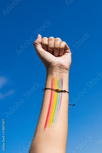 
Unrecognizable person with bracelet and colors of the LGTBI+ flag
LGTBI protest conceptual