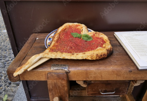 Special pizza exposed on the table in Brera district, Milan, Italy
