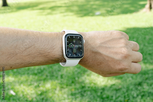 Smartwatch on Wrist in Outdoor Setting. © InfinitePhoto