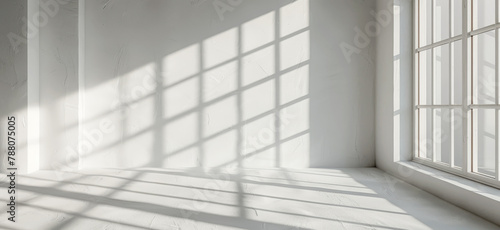 Abstract shadow patterns on a white wall in a minimalist room