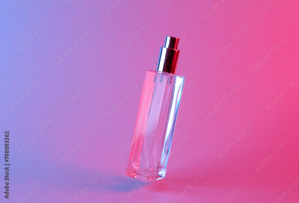 Floating perfume bottle in blue-pink gradient neon light Floating perfume bottle in blue-pink gradient neon light