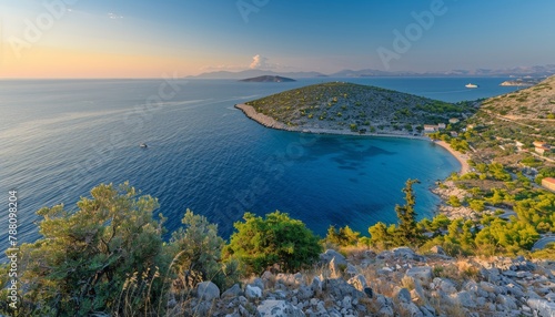 Tranquil island panorama from mountaintop at sunrise, showcasing sandy beaches and lush green hills