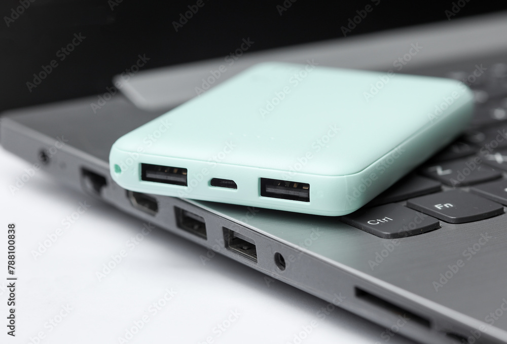 Laptop with power bank on white background Laptop with power bank on white background