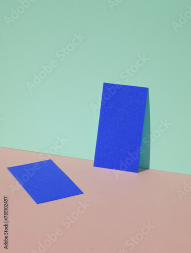 Yellow blank business cards on a blue-pink pastel background. Creative minimal layout. Corporate identity