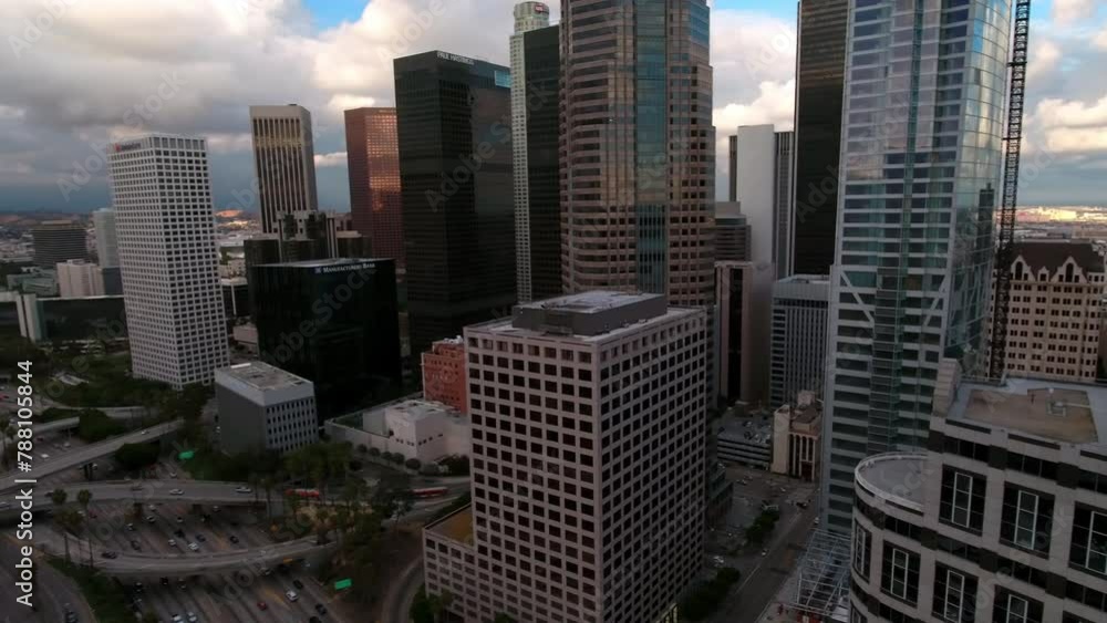 Aerial Panning Shot Of Modern Downtown With Vehicles On Roads In City Against Sky - Los Angeles, California