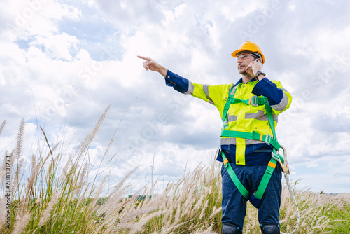 engineer male control operate field working outdoor service maintenance wind power generator. worker hand pointing location to order gesture © Quality Stock Arts