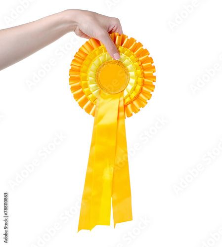 Yellow award ribbon in hand on white background isolation