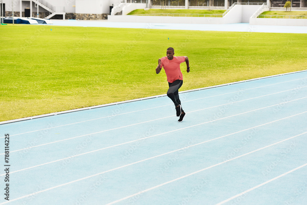 Fitness, black man and running on race track for athletics, sprint challenge or competition training in stadium. Runner, exercise and male person for performance, endurance or cardio workout
