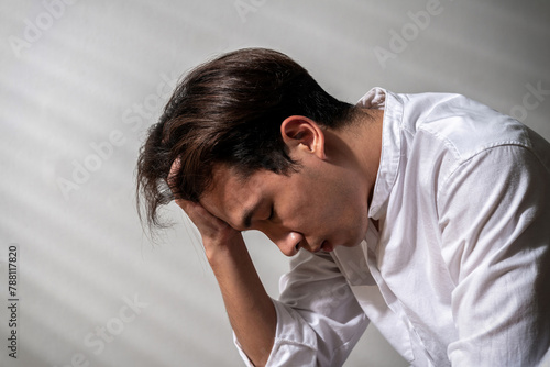 stress asian man nervous headache alone. loneliness frustration male person suffering from isolated tired pressure indoors. lonely attractive mental people depressed pain sad grief with difficulty