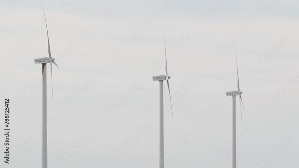 Wind turbines at dawn blue sky with clouds Wind farm generating green energy.Wind turbine blades rotate against a blue sky on a sunny day. Energy production with renewable energy. Wind turbines at dawn blue sky with clouds Wind farm generating green energy.Wind turbine blades rotate against a blue sky on a sunny day. Energy production with renewable energy.