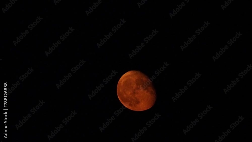 reddish moon zoom. moon video. detail of a moonlit night in a black and clear sky reddish moon zoom. moon video. detail of a moonlit night in a black and clear sky