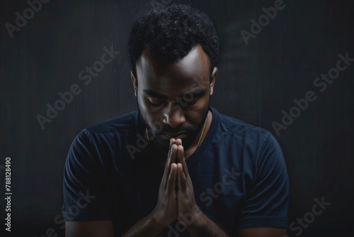Faith, christian and praying black man in dark background with trust, hope or gratitude with prayer. Religion, male person and hands together to seek guidance, wisdom or blessings for personal growth