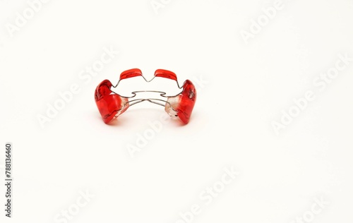 Red braces on white background
