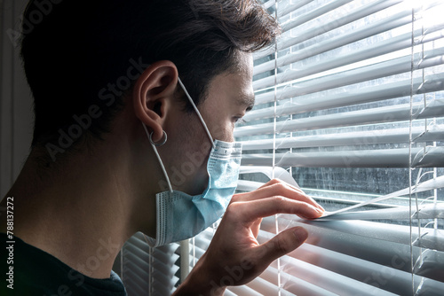 asian man wear mask looking window. sad guy looking pain suffering emotion expression at window. loneliness sad grief moody pressure asian young adult person desperate from suffering pain in people