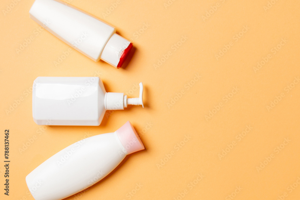 Set of White Cosmetic containers isolated on colored background, top view with copy space. Group of plastic bodycare bottle containers with empty space for you design Set of White Cosmetic containers isolated on colored background, top view with copy space. Group of plastic bodycare bottle containers with empty space for you design
