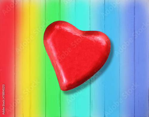 Rea heart on a wooden table with rainbow peace background with copy space for your textb