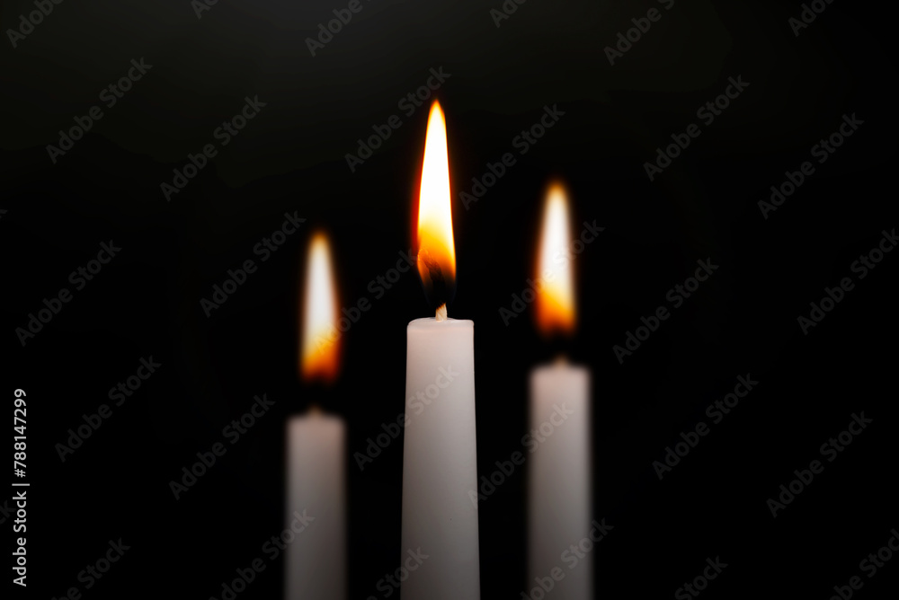 Funeral symbol with burning candle in darkness Funeral symbol with burning candle in darkness