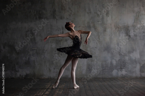 Ballerina in a black tutu performs the part of the black swan from Tchaikovsky's ballet Swan Lake. photo