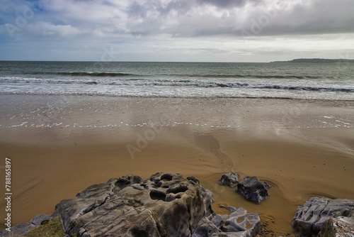 The Beach, Rocks, Sand, Waves And Clouds