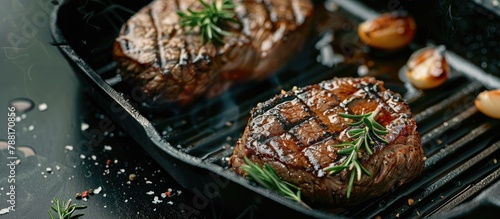 A hot beef tenderloin steak is being grilled in a grill pan with text space. The recipe concept is for filet mignon.