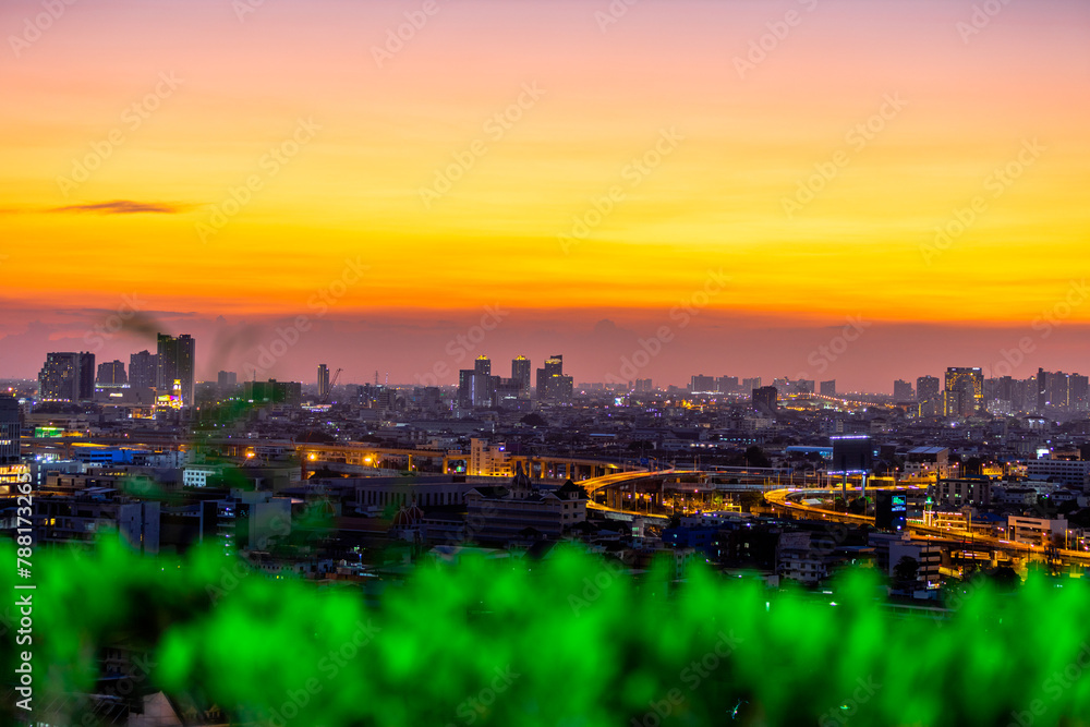 High angle background of the evening atmosphere of the condo rooftop overlooking the twilight sky and houses. Tall buildings and blurry lights in the business district High angle background of the evening atmosphere of the condo rooftop overlooking the twilight sky and houses. Tall buildings and blurry lights in the business district