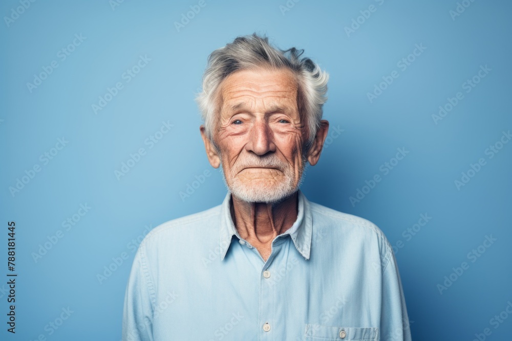 Portrait of a happy elderly 100 years old man sporting a versatile denim shirt on minimalist or empty room background Portrait of a happy elderly 100 years old man sporting a versatile denim shirt on minimalist or empty room background