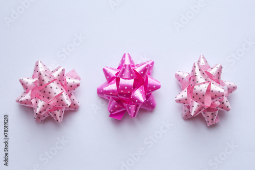 dotty pink bows on a white background, top view.