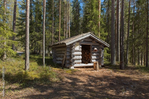 A shelter to keep firewood dry at campsite at Kirkasvetinen lake in spring, Hossa National Park, Suomussalmi, Finland. © Raimo