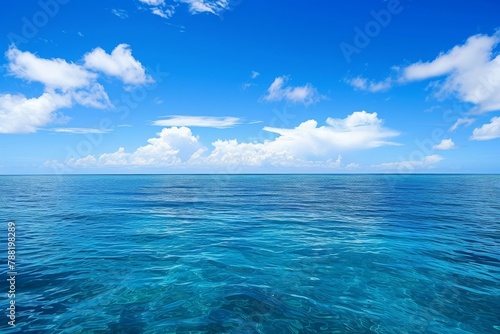 A photograph of a body of water with clouds hovering in the sky above, An endless blue ocean under a clear day sky, AI Generated