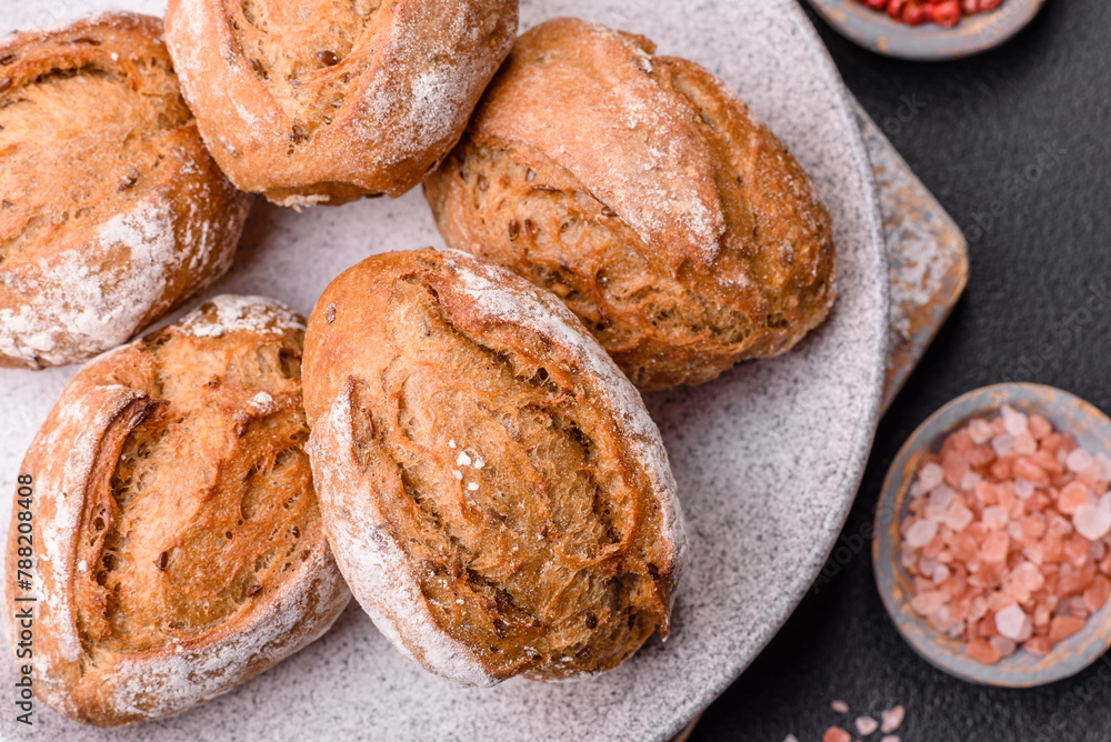 Fototapeta premium Fresh baked bread buns with salt, spices, seeds and grains