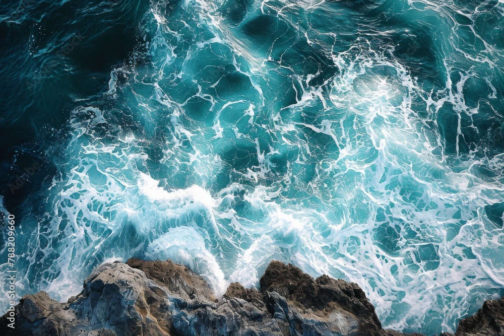 A captivating aerial perspective of the powerful ocean waves relentlessly crashing against the solid rocks below, Artistic interpretation of aerial view of sea waves hitting the rocks, AI Generated