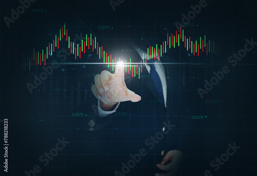 Businessman Touching the trading graph in green and red color with glowing light, dark backdrop. Business and trading concept background