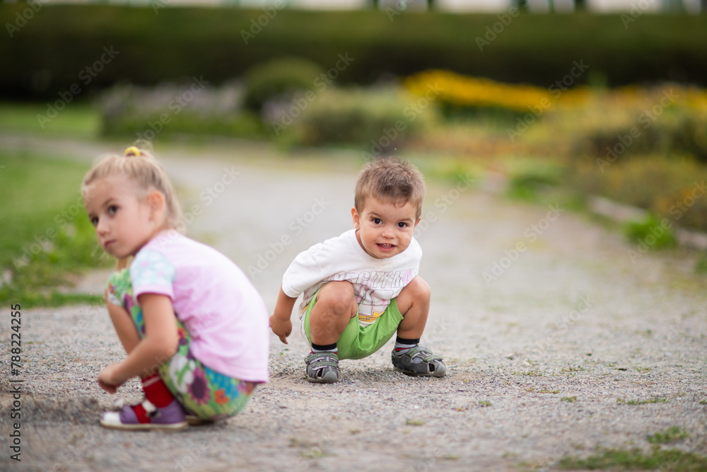 children sitting on the grass, kids playing in the garden, childhood, brother and sister playing together, baby drinking water children sitting on the grass, kids playing in the garden, childhood, brother and sister playing together, baby drinking water