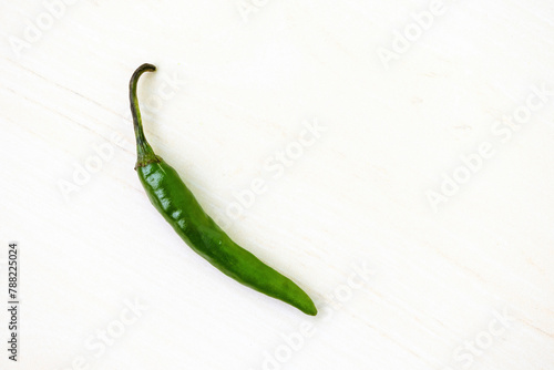 Fresh green hot chili pepper on a white background. Top view photo