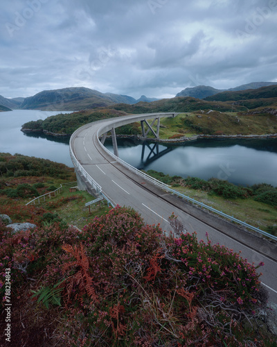 Curved bridge that crosses the lake in autumn. Kylesku Bridge crossing the Loch a Chairn Bhain in Sutherland, on the North Coast 500, Scotland