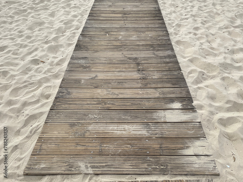 Wooden pier lying on a sandy beach
