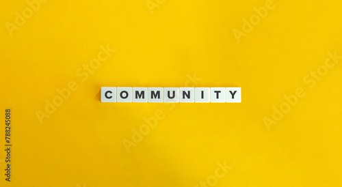 Community Word. Text on Letter Tiles on Yellow Background. Minimalist Aesthetics. photo