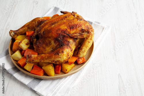 Homemade Hearty Roasted Chicken on a Plate, side view. Space for text. © Liudmyla