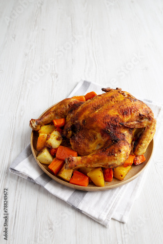 Homemade Hearty Roasted Chicken on a Plate, side view. Copy space.