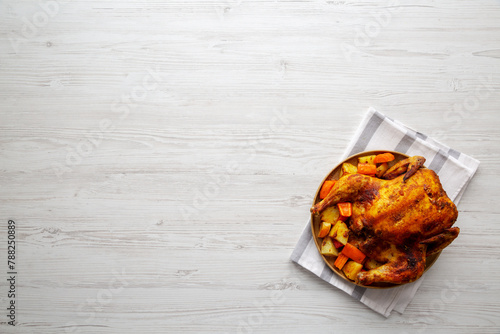 Homemade Hearty Roasted Chicken on a Plate, top view. Space for text. © Liudmyla