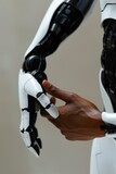 A robot hand holding a black object in its palm, AI