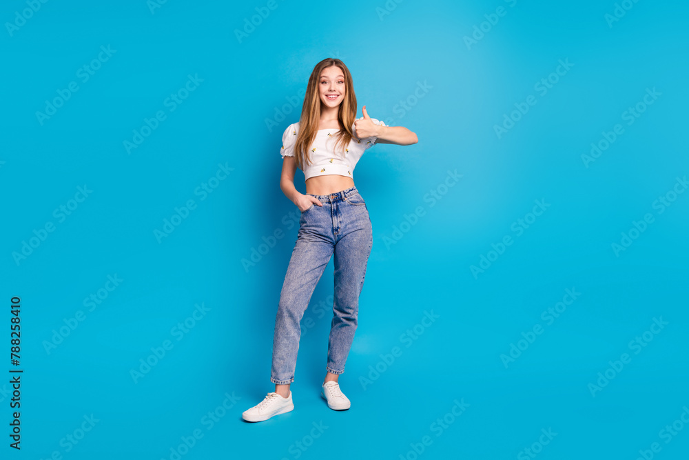 Obraz premium Photo of positive girl stand make thumb up sign isolated blue color background
