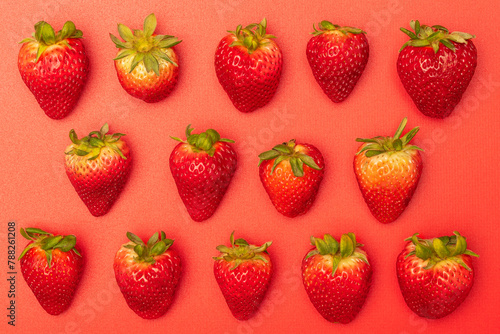 Fresh strawberries on a bright red background
