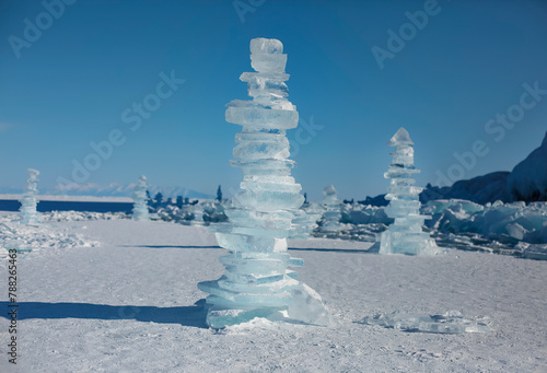 Pieces of ice lying on the ideal smooth ice of baikal with ice hummocks in the horizon © Dasha Petrenko
