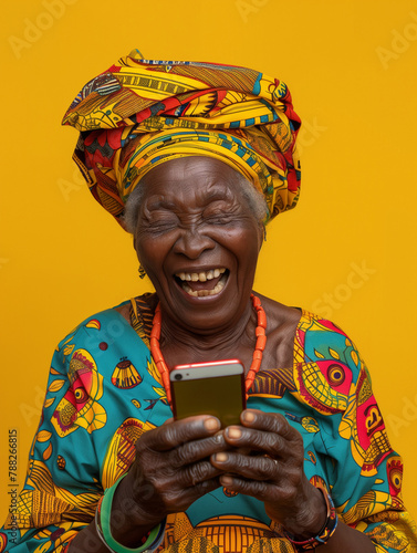 Old woman from West Africa, laughing out loud at something she has seen on a phone. Image bringing joy.